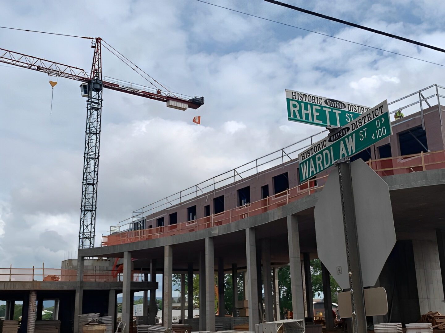 Construction site with crane and street signs.