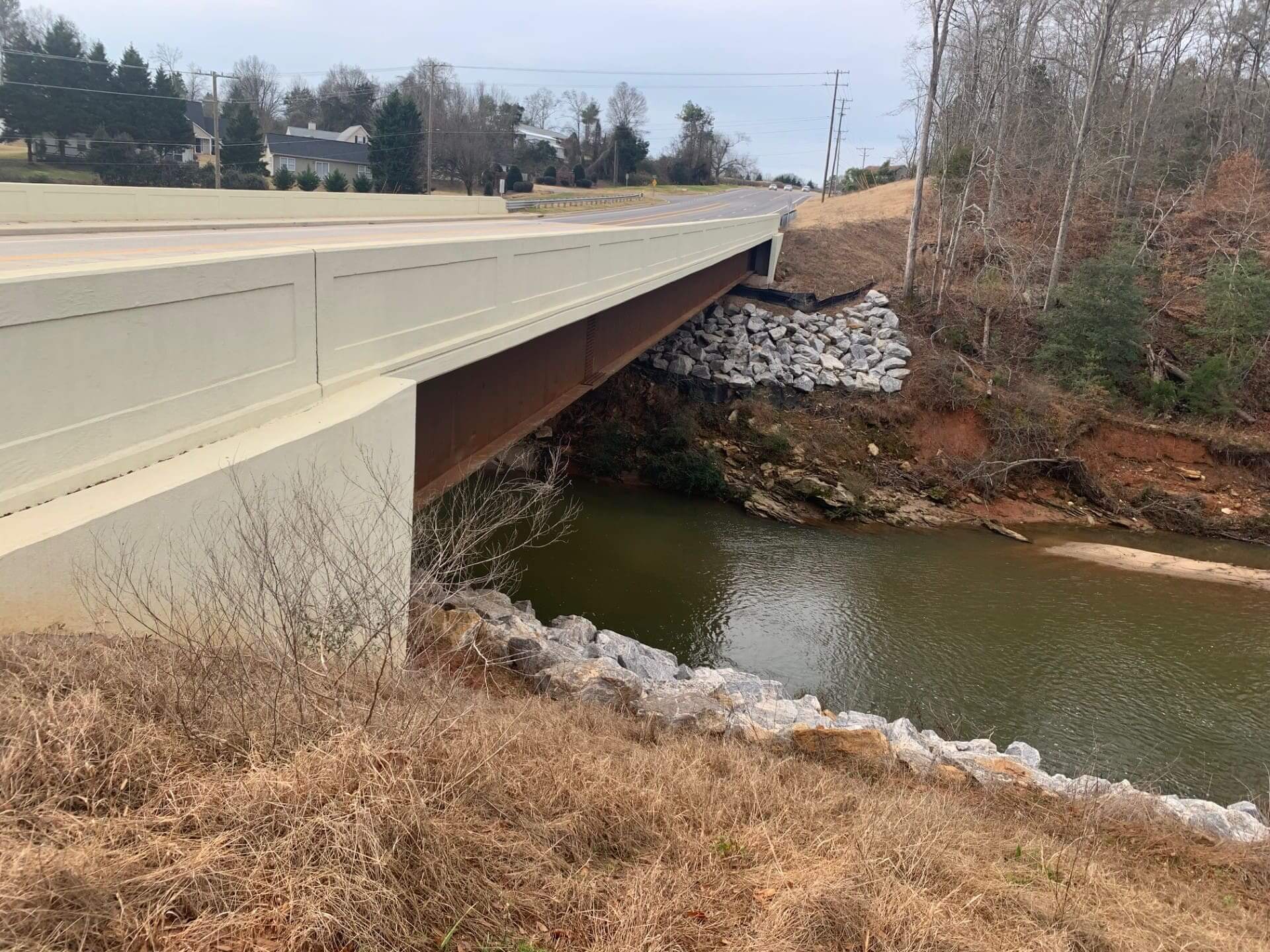 Bridge over a river with rocky bank.