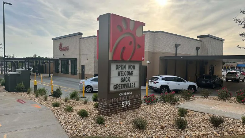 Chick-fil-A restaurant with welcoming sign outside.