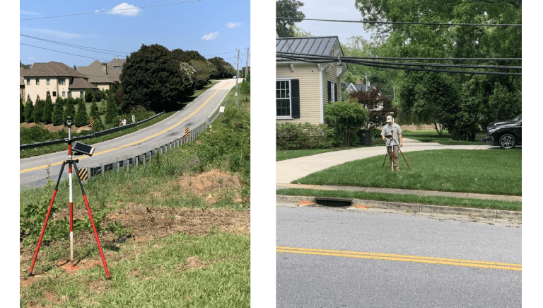 Surveying equipment set up near residential street.