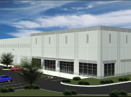 Modern industrial building with parking lot.